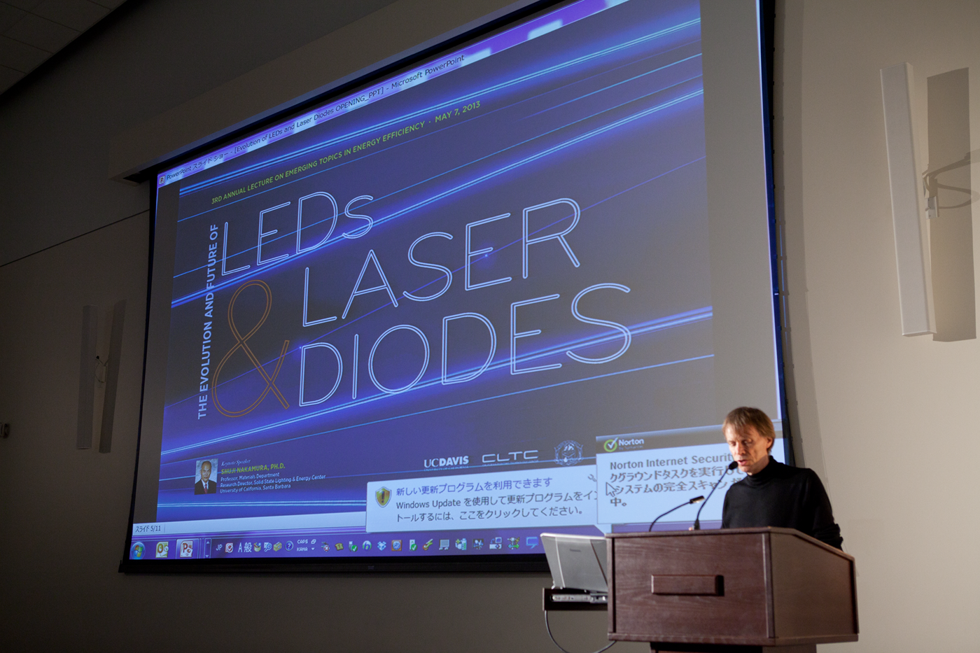 Aumann Lecture 1 - (A person standing at a podium in from of slides that says "LED's Laser Diodes")