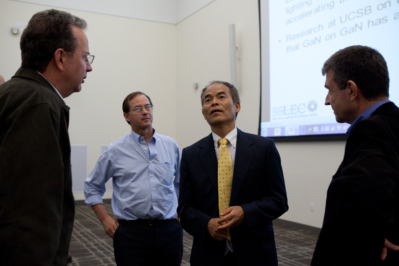 Aumann Lecture 7 - (Four people standing and talking)