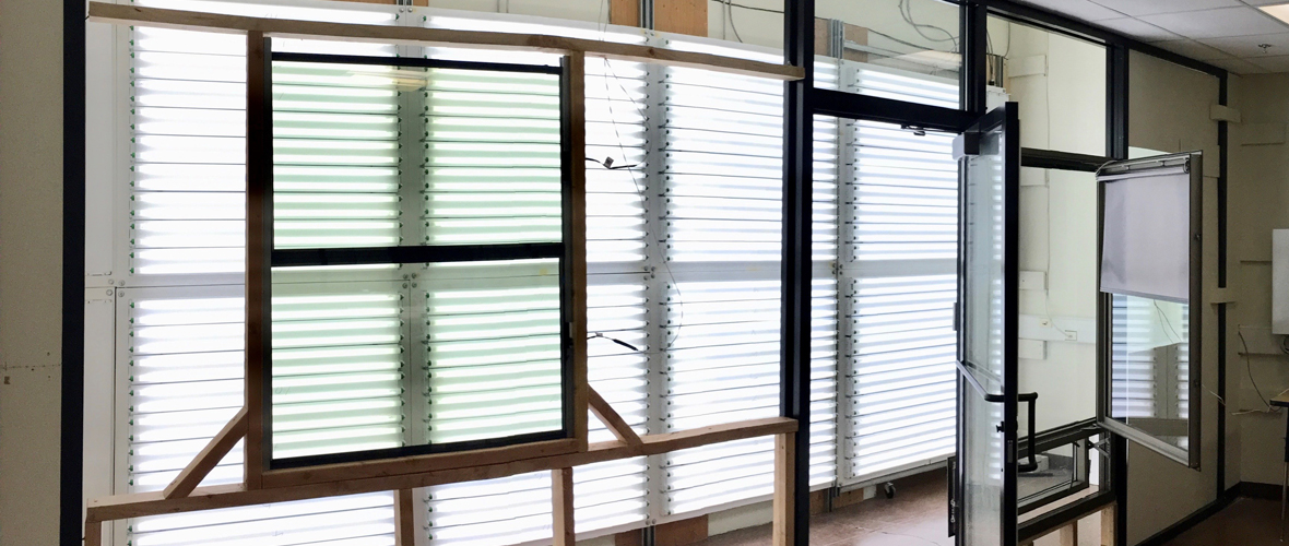 A grid of windows with different blinds and ways to control daylight entering the interior