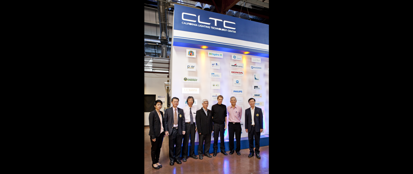 Seven people wearing formal attire lined shoulder to shoulder up for a photo under the CLTC logo