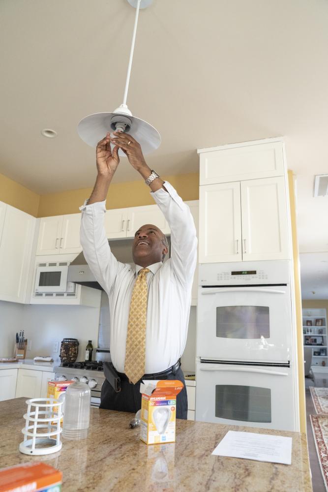 Gary May changing a light bulb