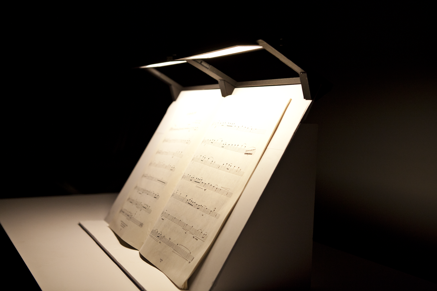 Light fixture placed over sheet music