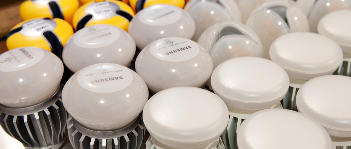 A close up photo of multiple light bulbs stacked up with a Samsung logo on the bulb 