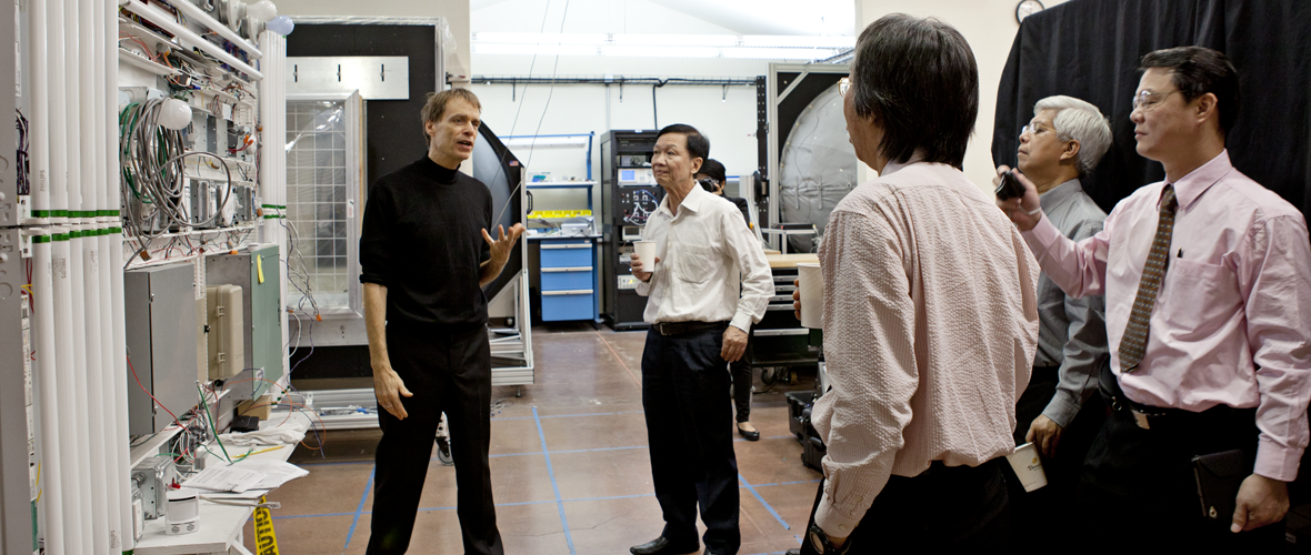 A person talking to a group of four people