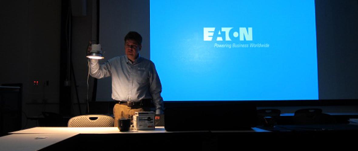 Person standing in front of a powerpoint presentation
