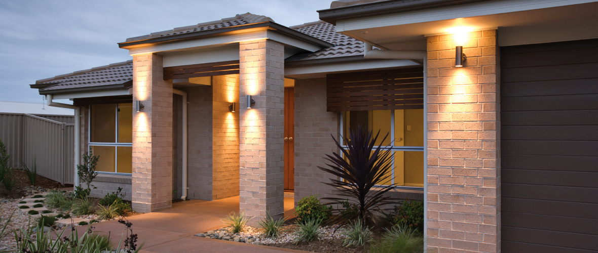 A residential house with exterior nighttime lighting 