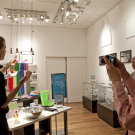 A person standing and talking in front of three other people in a retail store